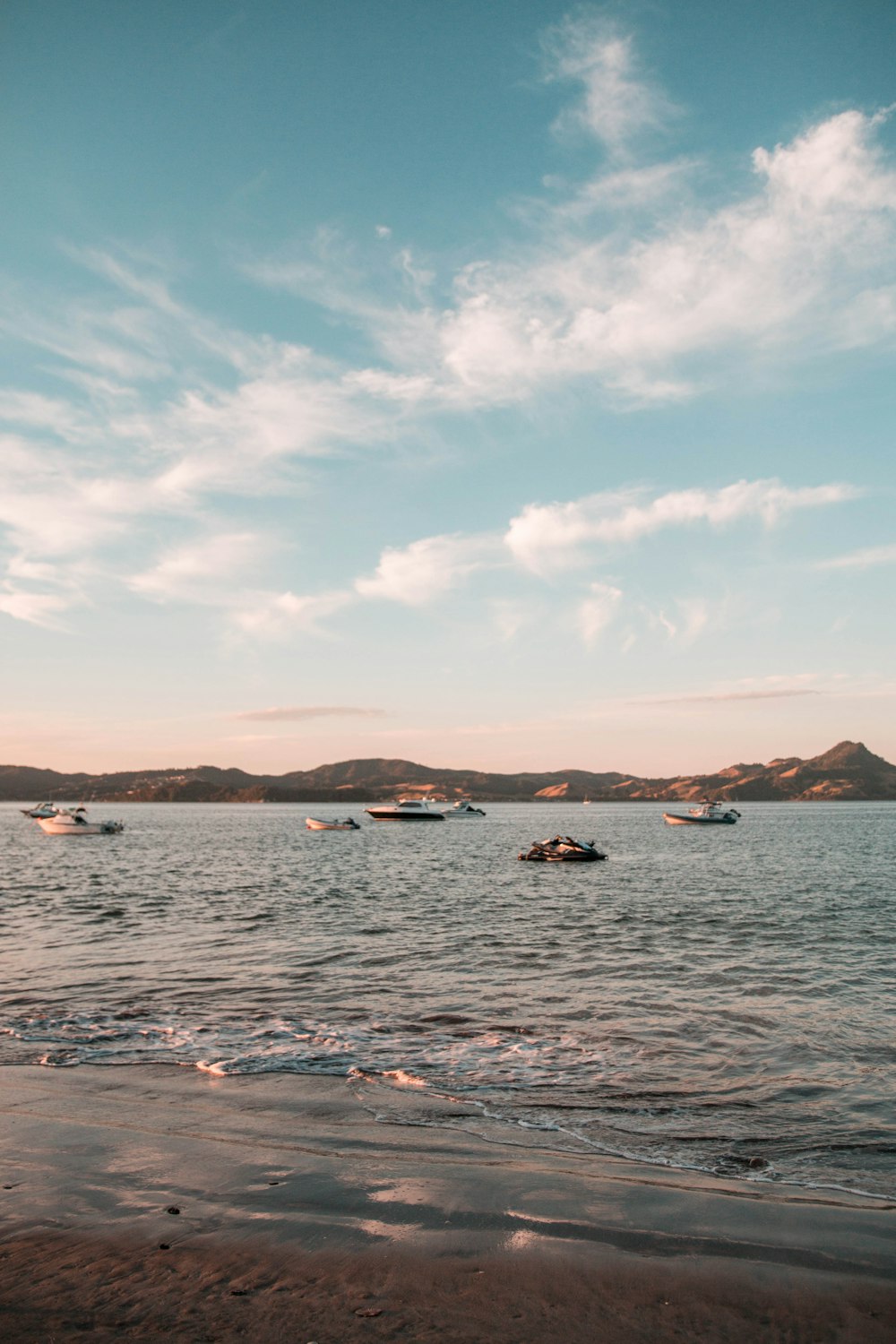 boats in sea under blue sky