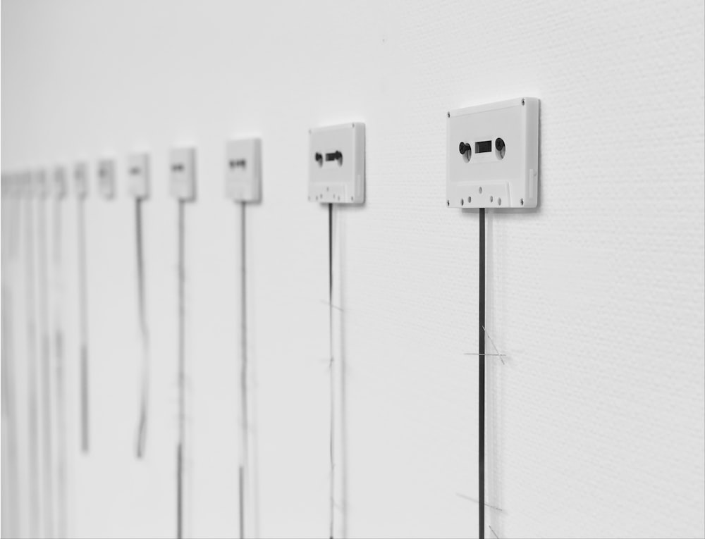 a row of white electrical outlets mounted to a wall