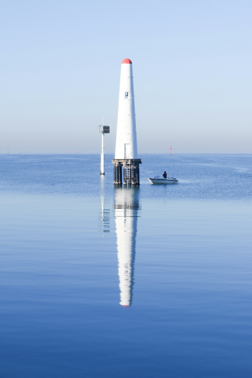 white tower on body of water