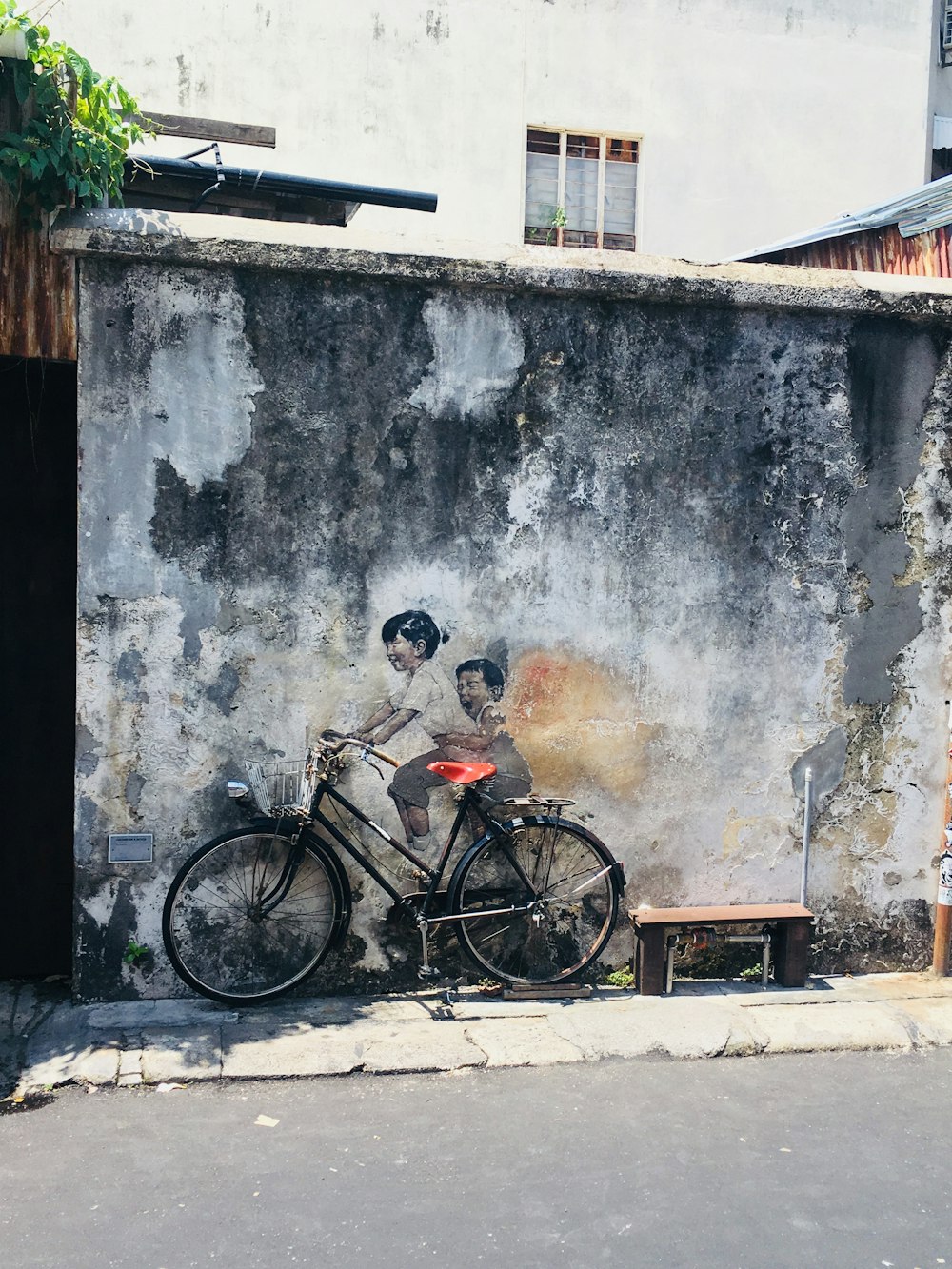 parked black bicycle painting