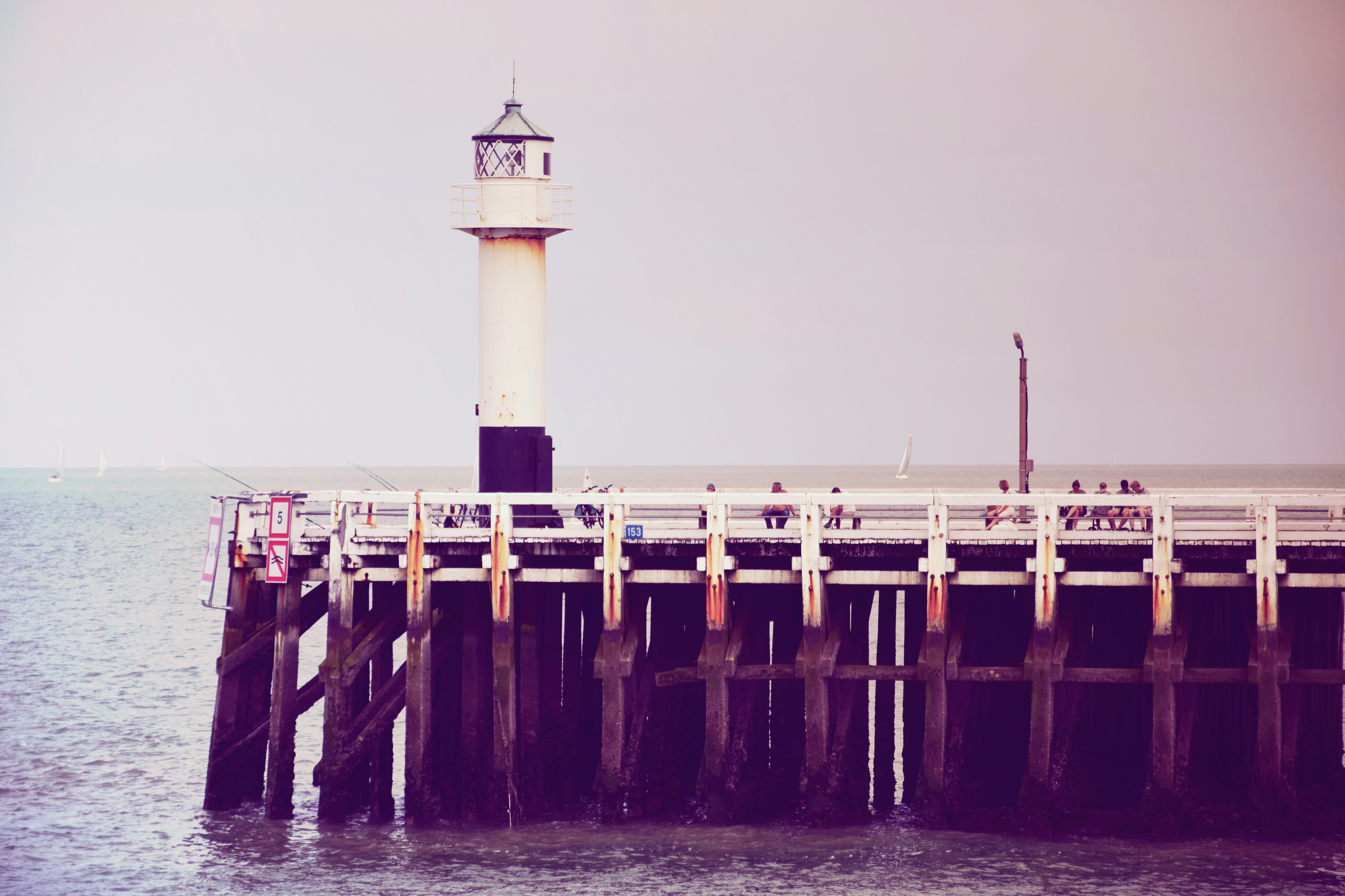 white and black lighthouse, Pier with lighthouse. Nieuwpoort, Belgium.