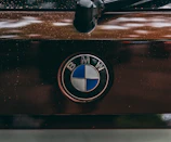 Close-up of BMW logo on a car part with a glossy finish.