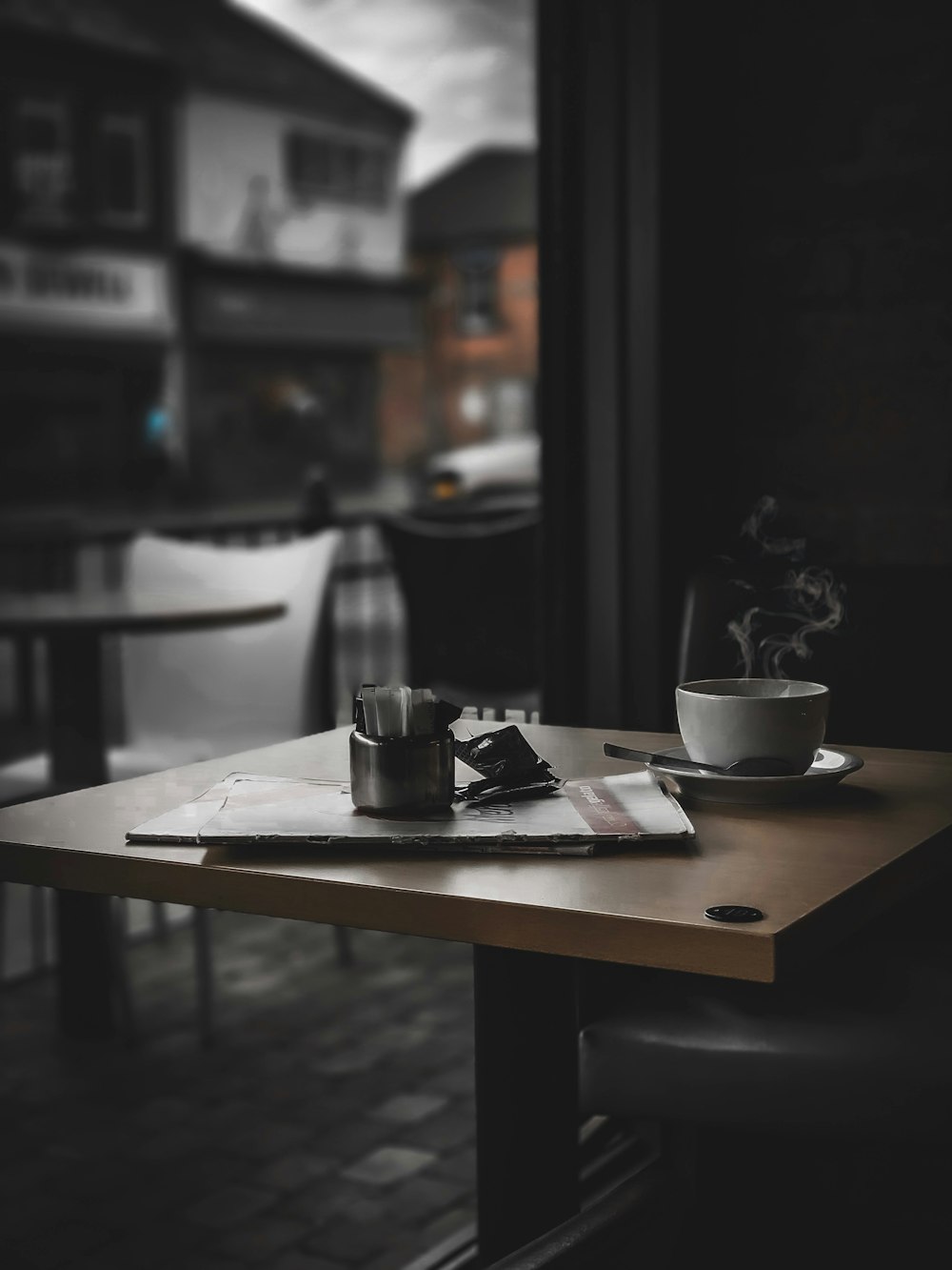 shallow focus photo of magazine on brown wooden table