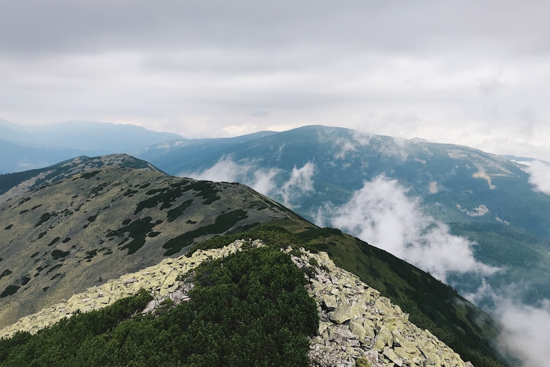 brown mountain under white clouds