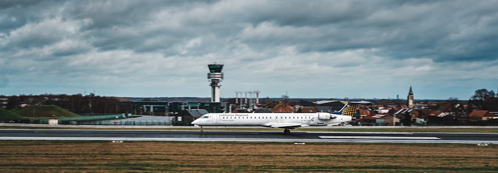 white airplane parked during daytime