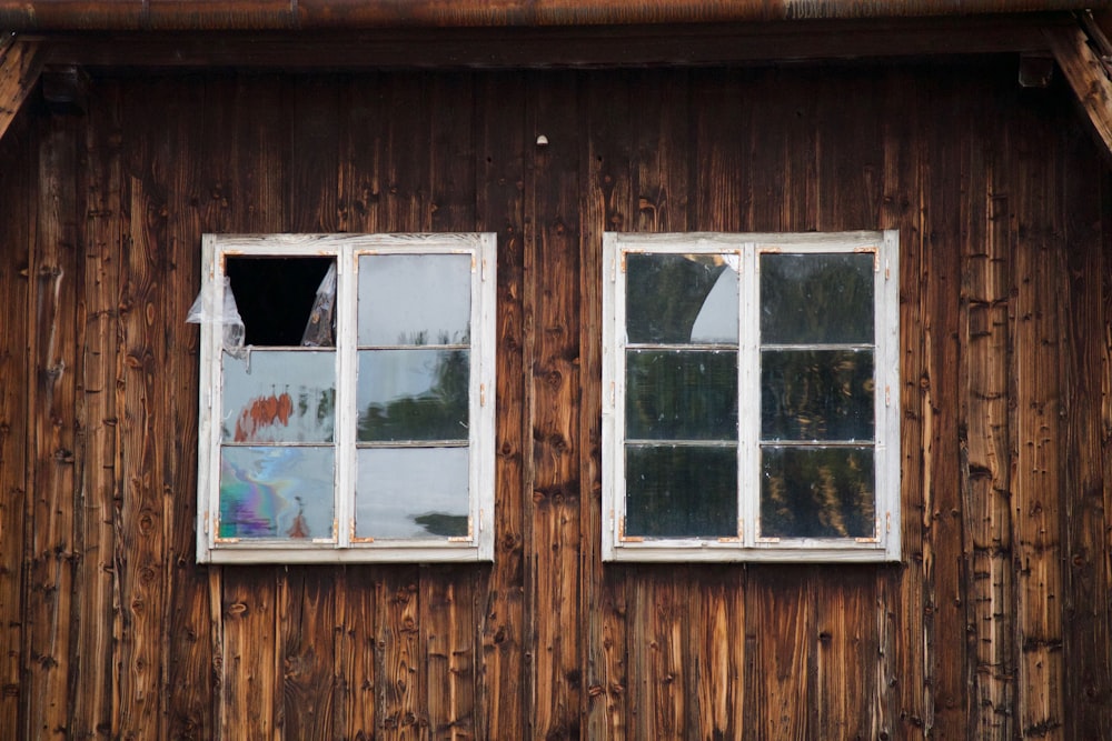 two white framed glass windows on brown wall