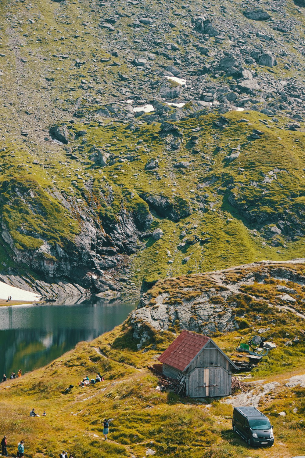 white and red wooden barn near body of water