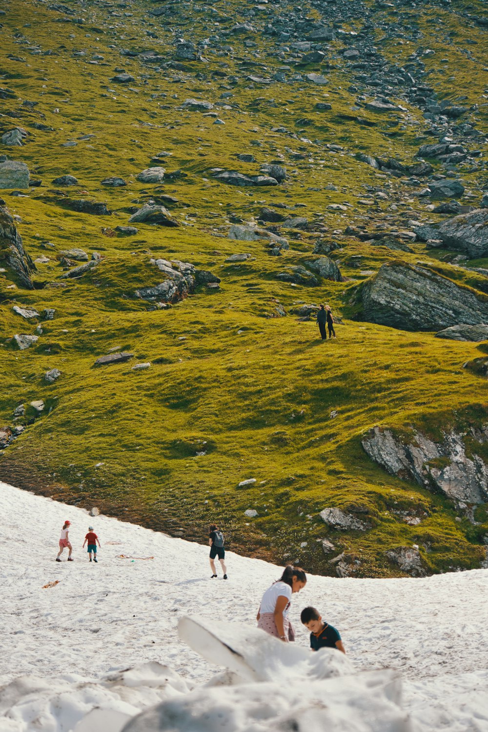 a group of people standing on top of a snow covered slope