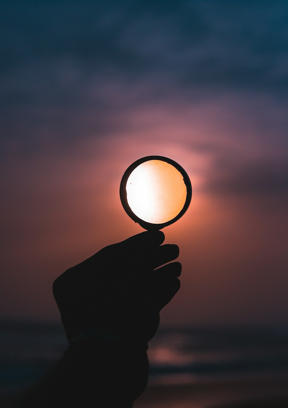 person holding magnifying glass