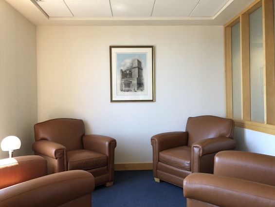 A warm, inviting room with soft brown and gold accents where a small group is engaged in a supportive rehabilitation session.