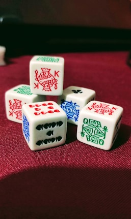 five playing dies on red cloth