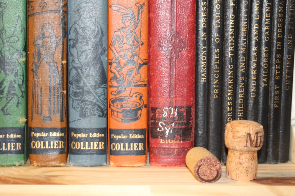 assorted book lot on brown wooden surface