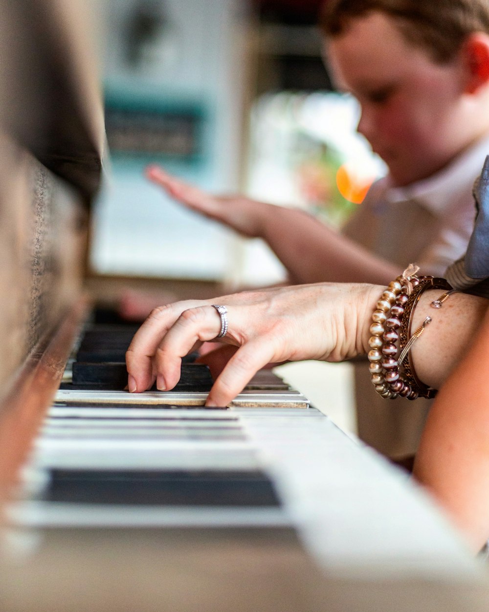 a woman is playing a piano with her hands