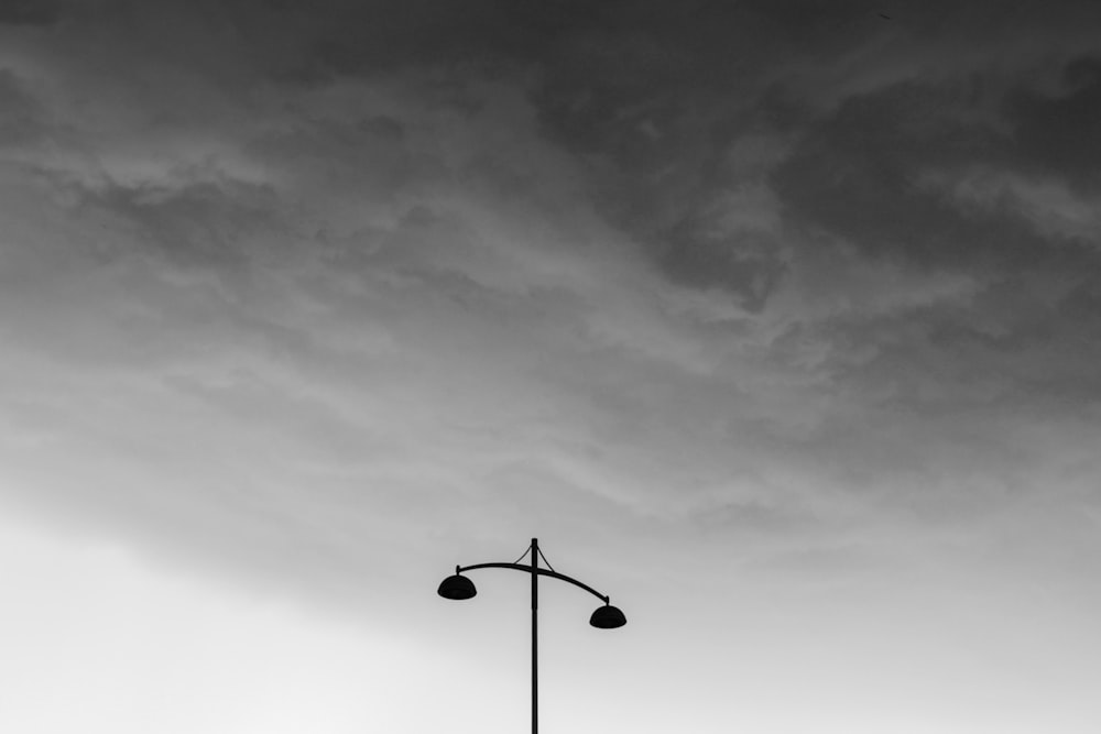 black street lamp under gray sky