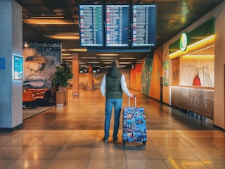 person standing with holding luggage bag