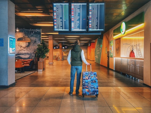person standing with holding luggage bag