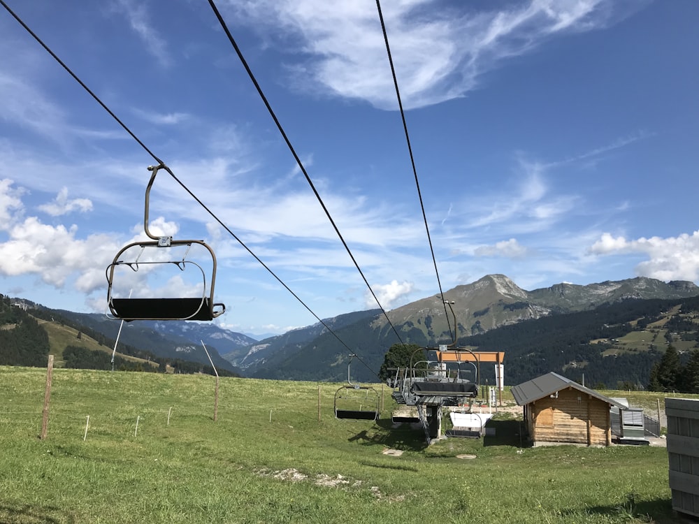 cable carts above grass field near buildings