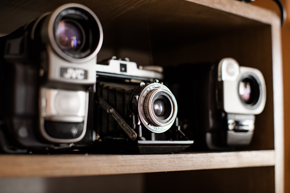 black and silver land camera near DSLR camera