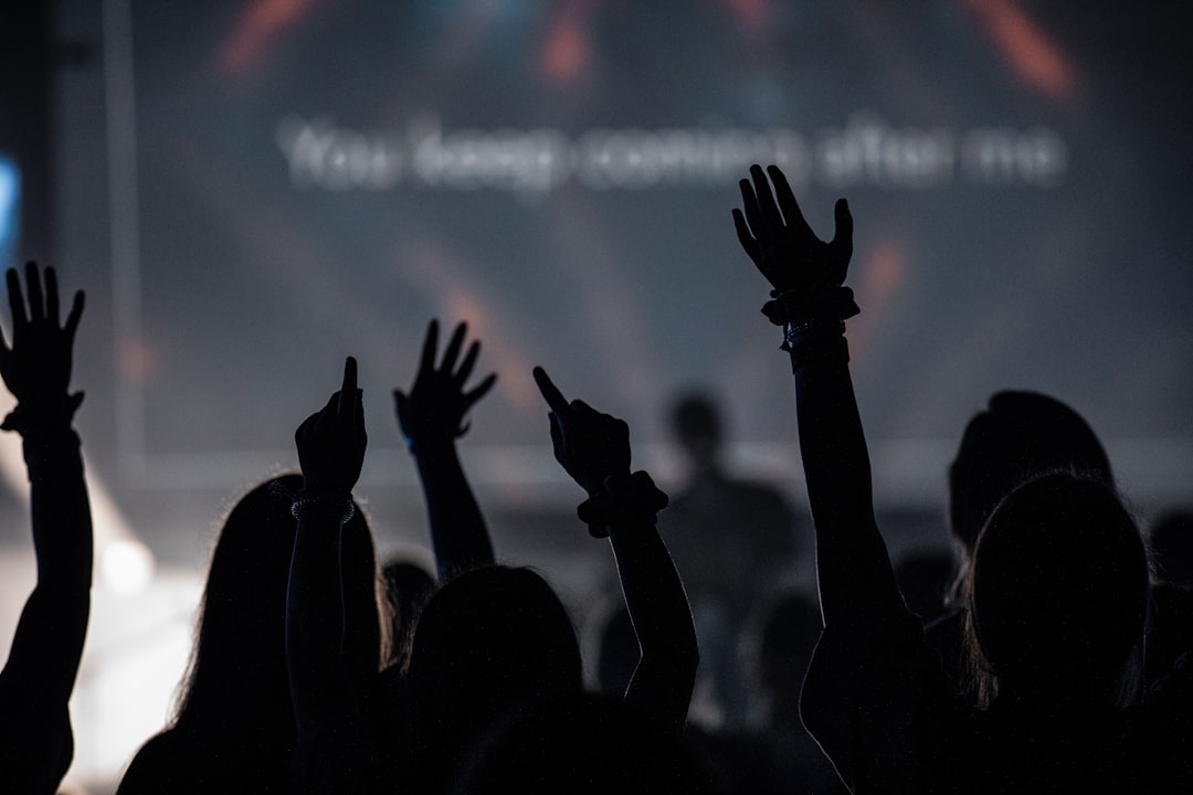 a group of people raising their hands in the air,