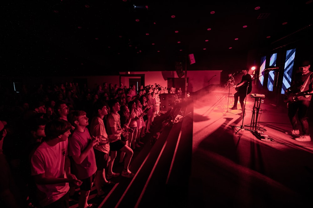 a man standing on a stage in front of a crowd