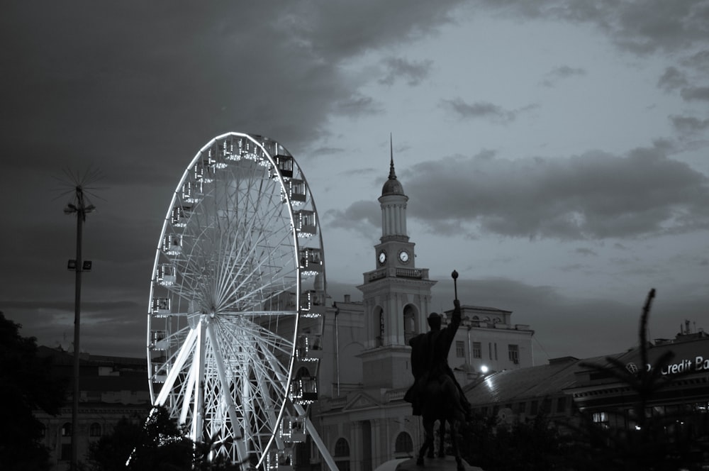 a black and white photo of a ferris wheel