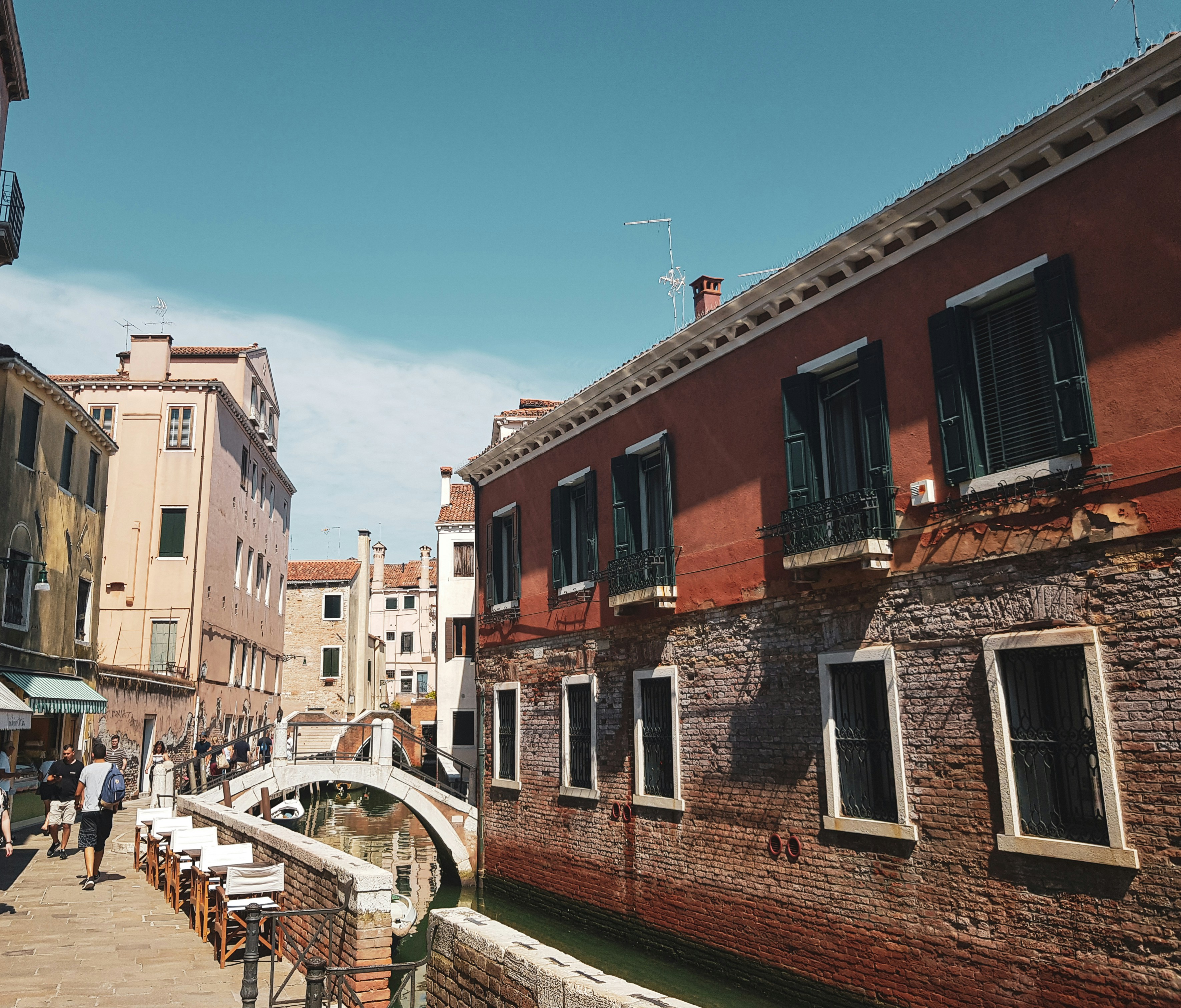a narrow canal runs between two buildings in a city