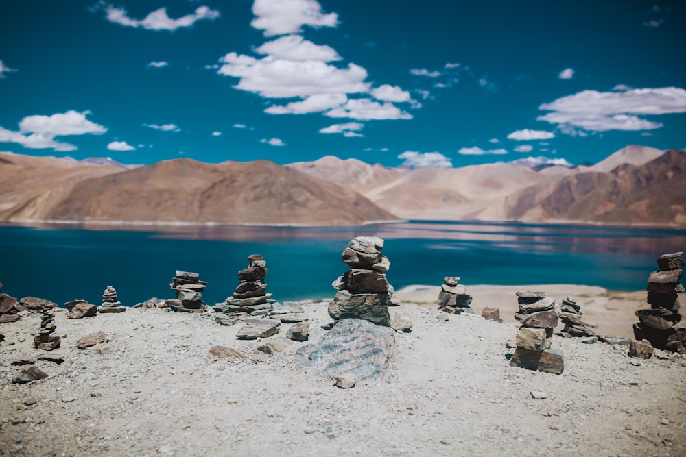 rock formation near calm body of water during daytime