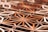 Intricate geometric wooden patterns with a three-dimensional effect, composed of various polygons and shapes. The use of warm colors with subtle variations gives it an artistic and architectural quality.