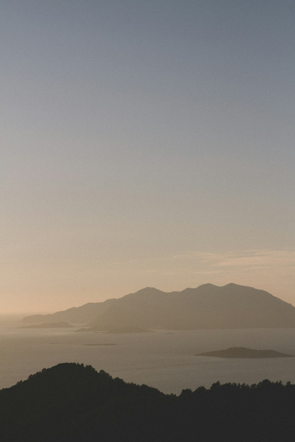 a view of a mountain range with a body of water in the distance