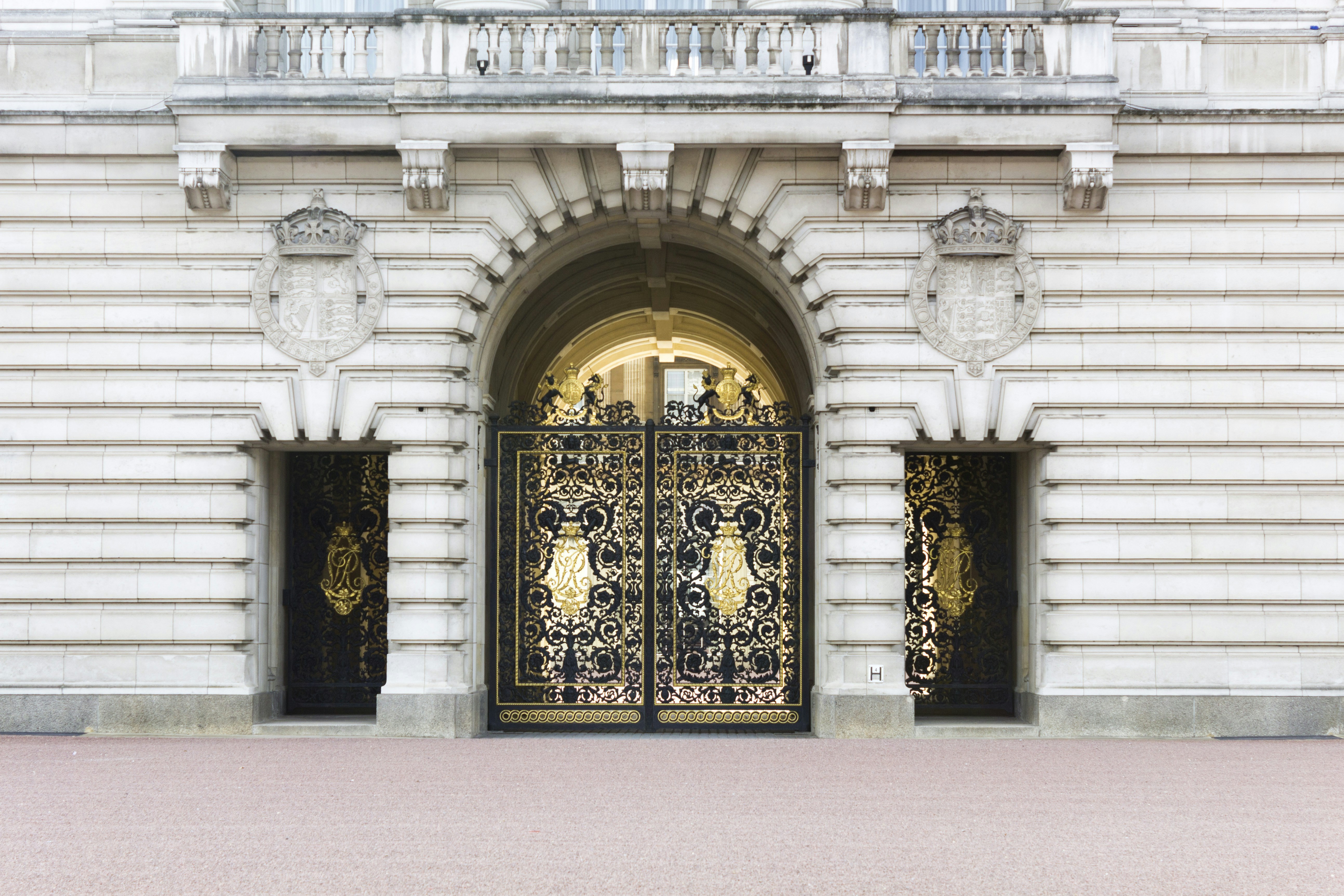 gray concrete building with brown and black floral door