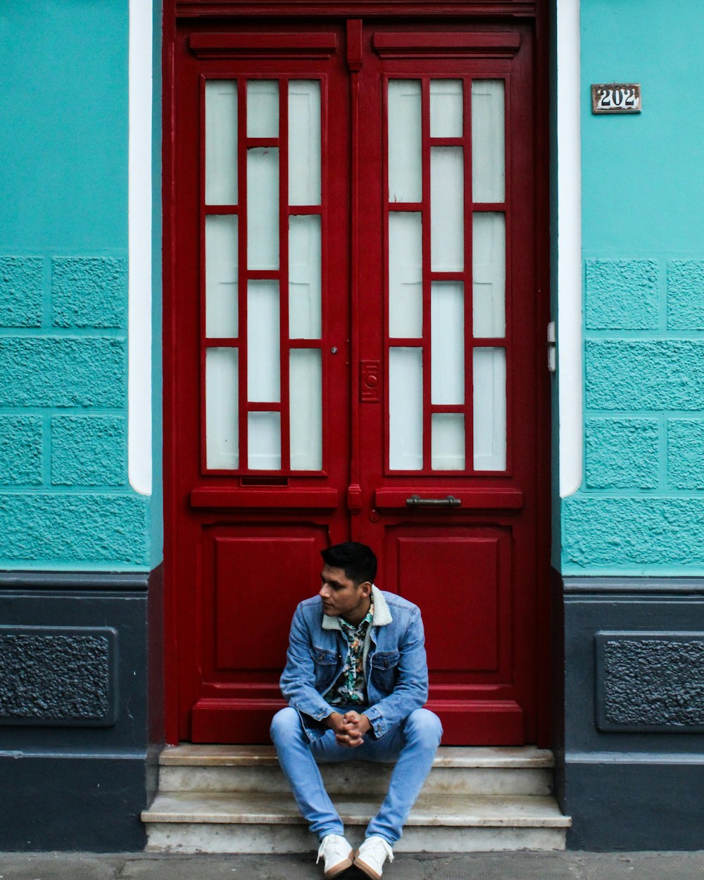 man sitting in front of door