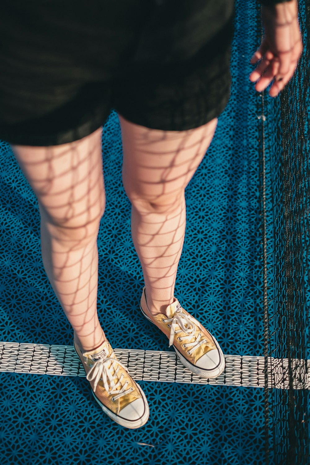 woman wears yellow low-top sneakers