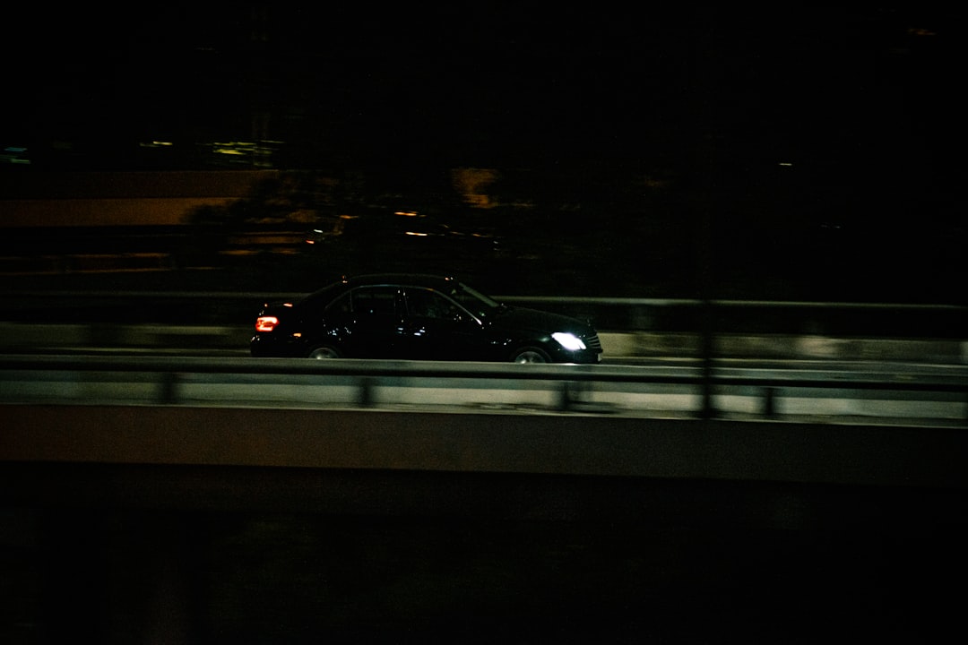 black vehicle on road at night