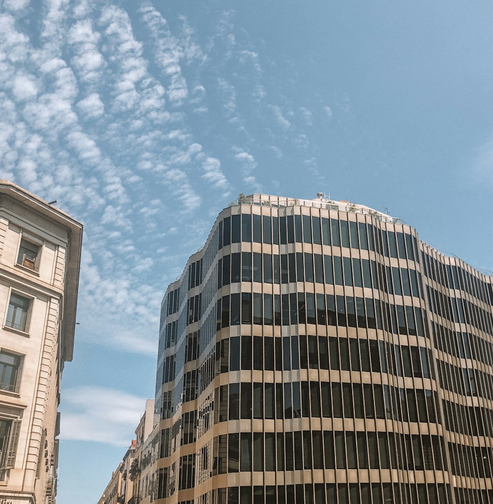 grey curtain building under blue clouds