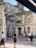 group of people standing near brown buildings