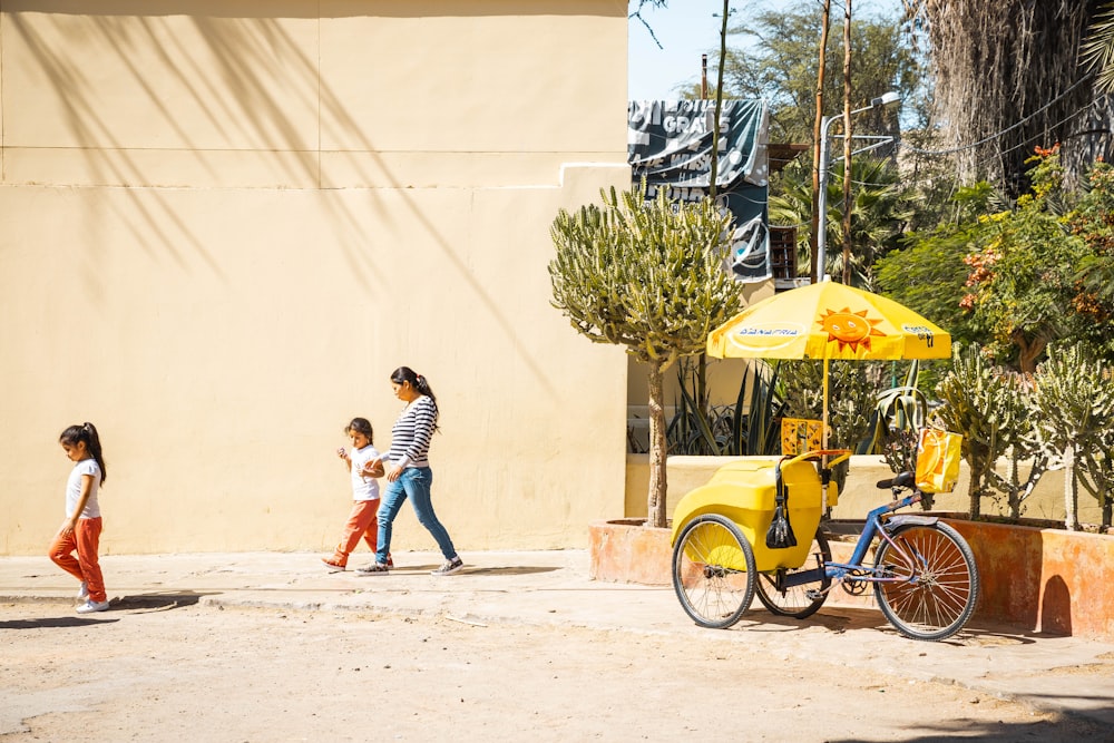 yellow trike beside green plants