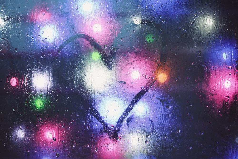 a close up of a window with a heart drawn on it