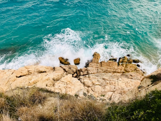 ocean wave crashing on rocks in Calella Spain