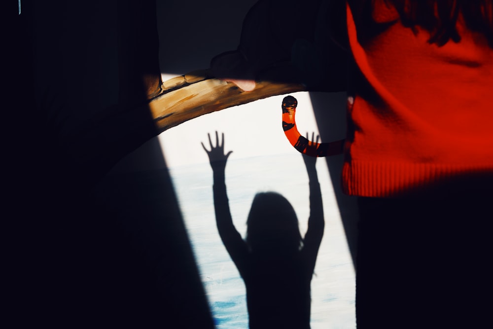 silhouette of children raising hand
