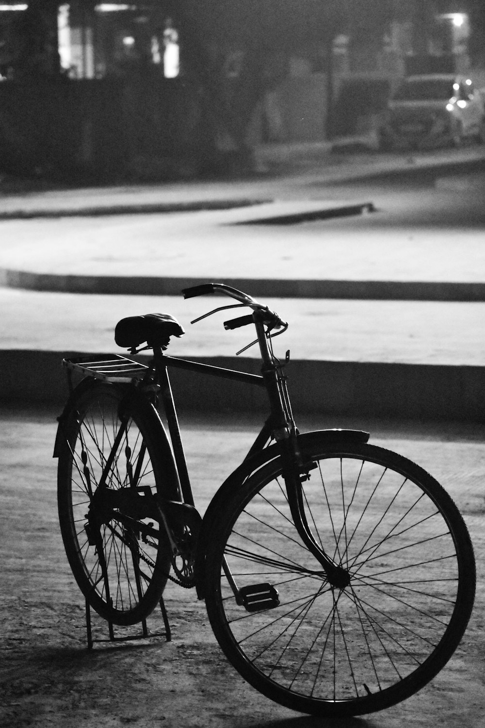 grayscale photography of bike parking near road