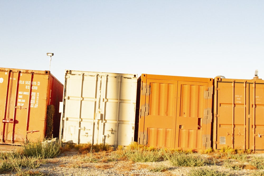 several orange and white cargo containers
