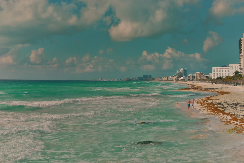 hotels and buildings near green sea under white and green sky during daytime