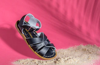Before and after images of a restored leather sandal showing renewed shine.