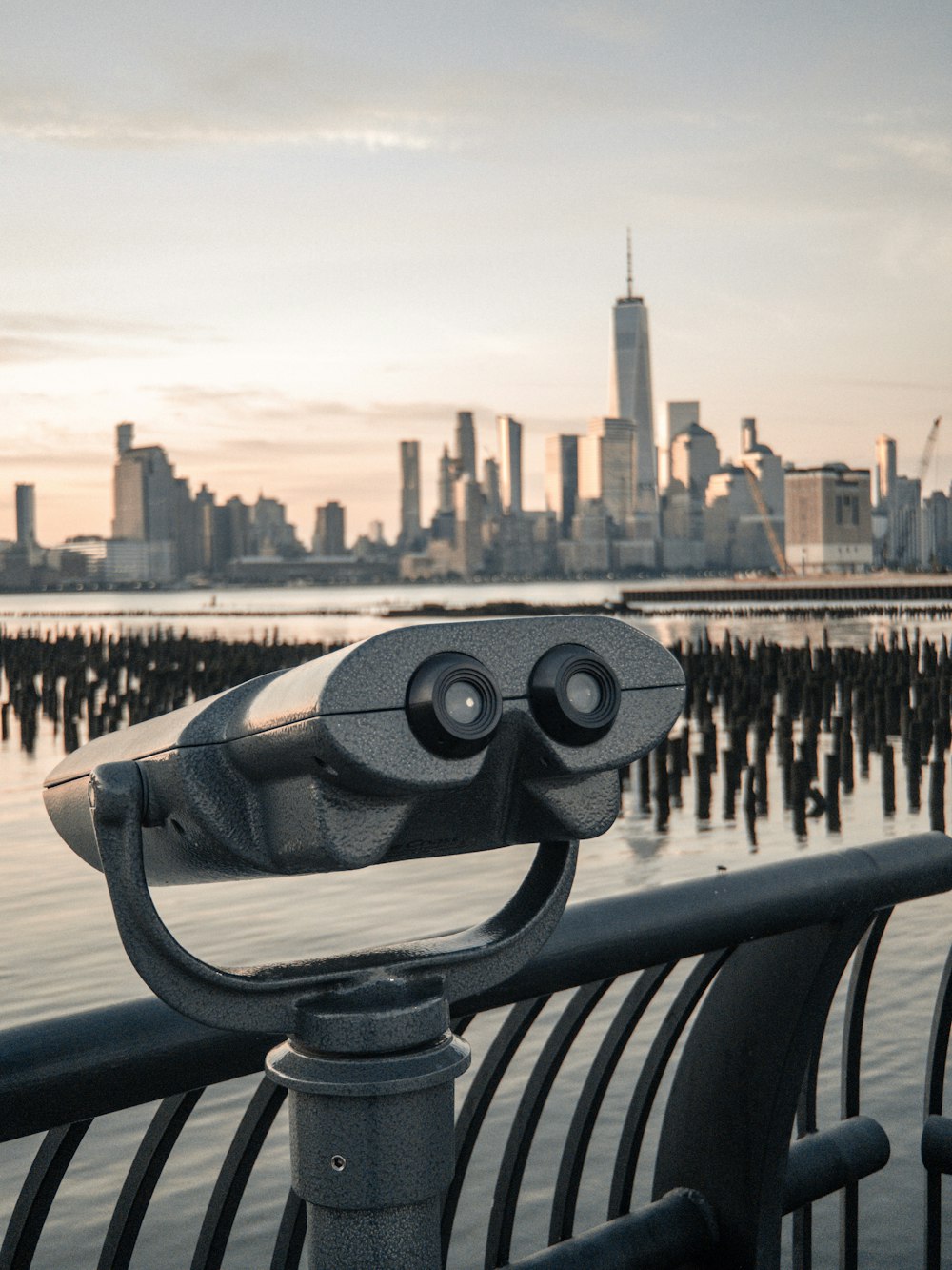 closeup photo of telescope near body of water