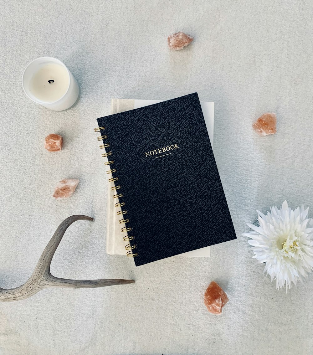 spiral notebook and flower