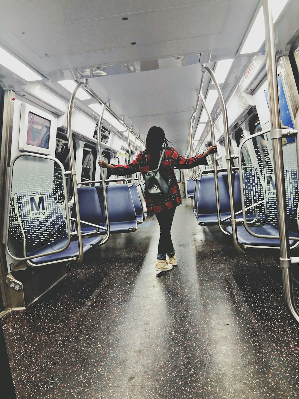 woman standing inside train