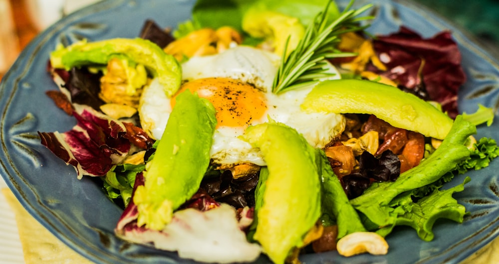 plate of vegetable salad and sunny side up egg