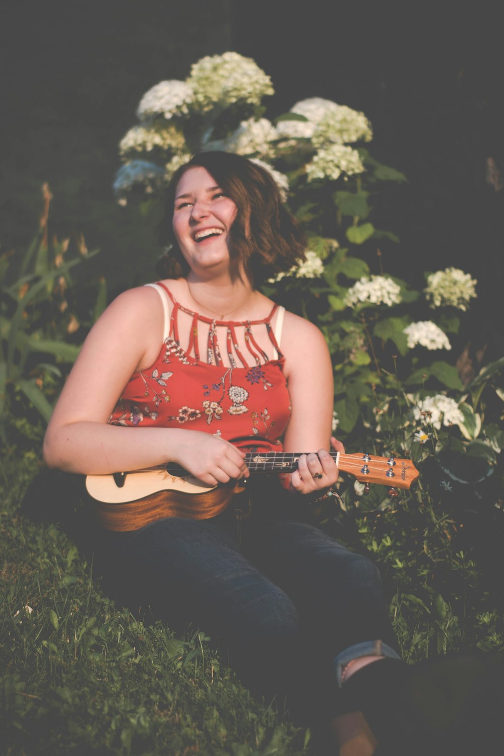 smiling woman playing ukulele
