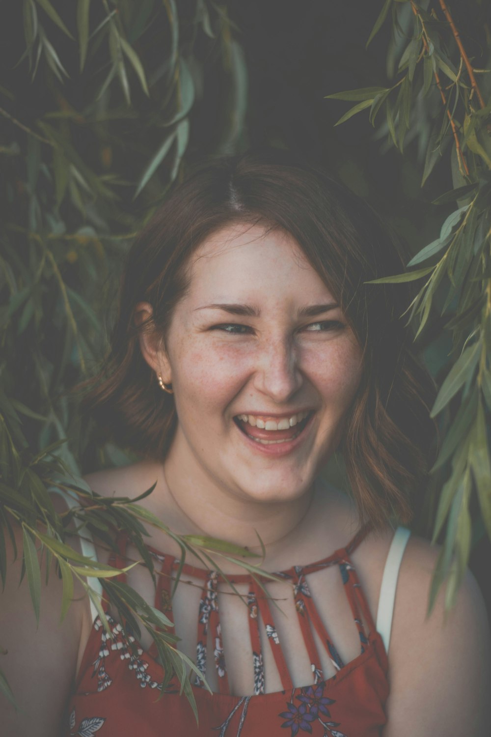 woman surrounded with green leaves