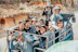 A group of happy travelers enjoying a scenic outdoor location during an international group trip.